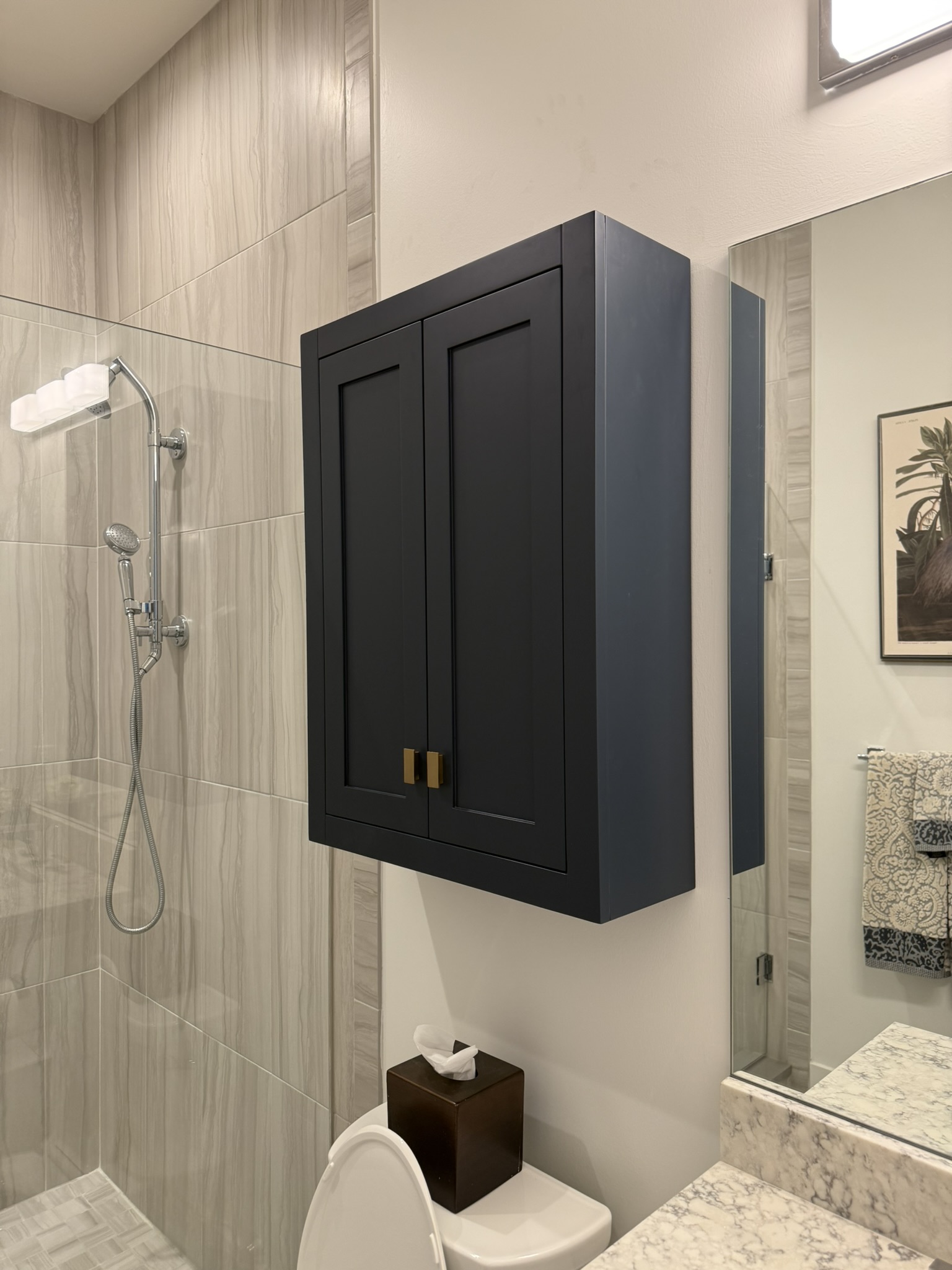 Navy wall cabinet installed in bathroom