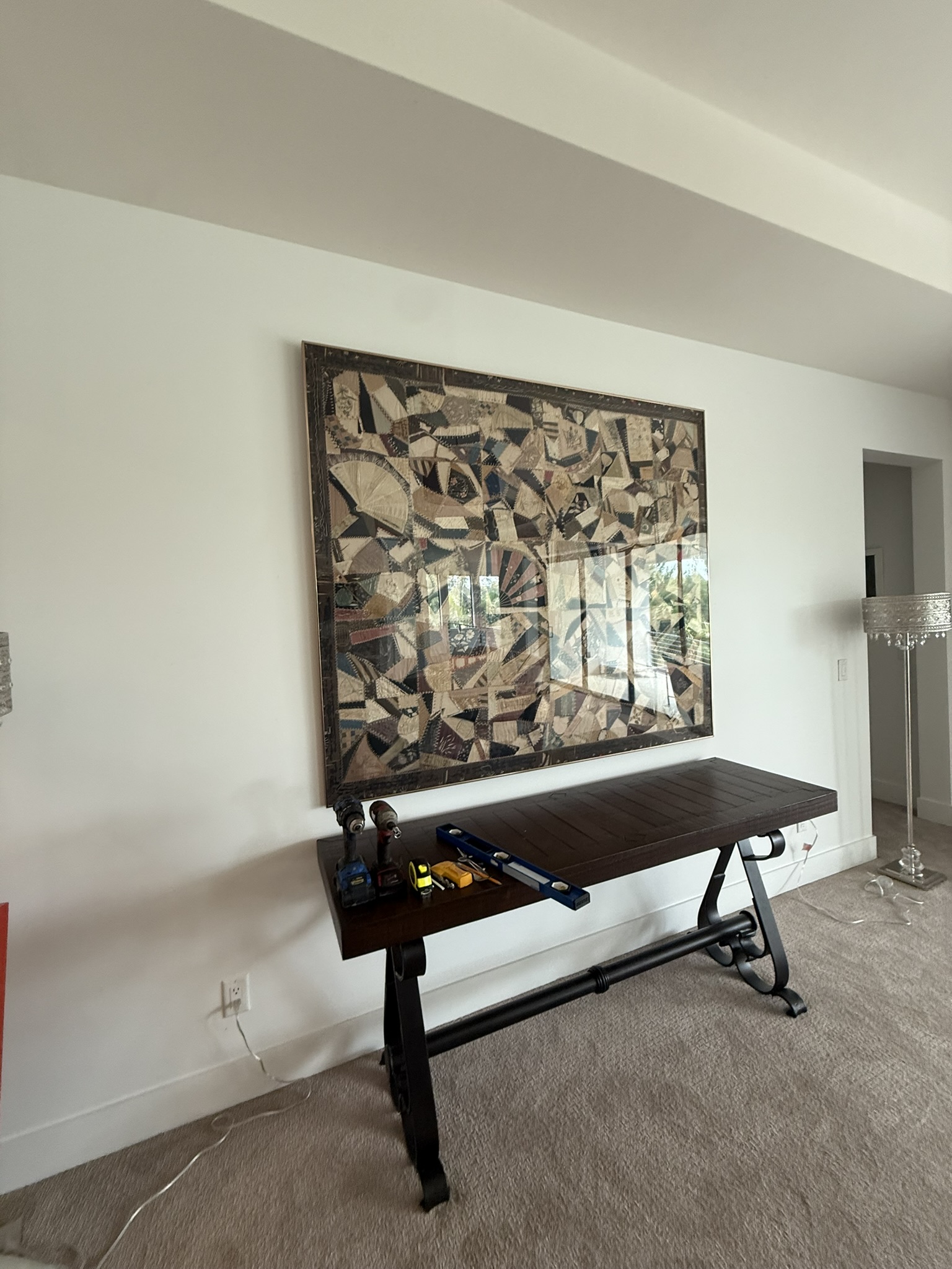 Large framed artwork hung over console table