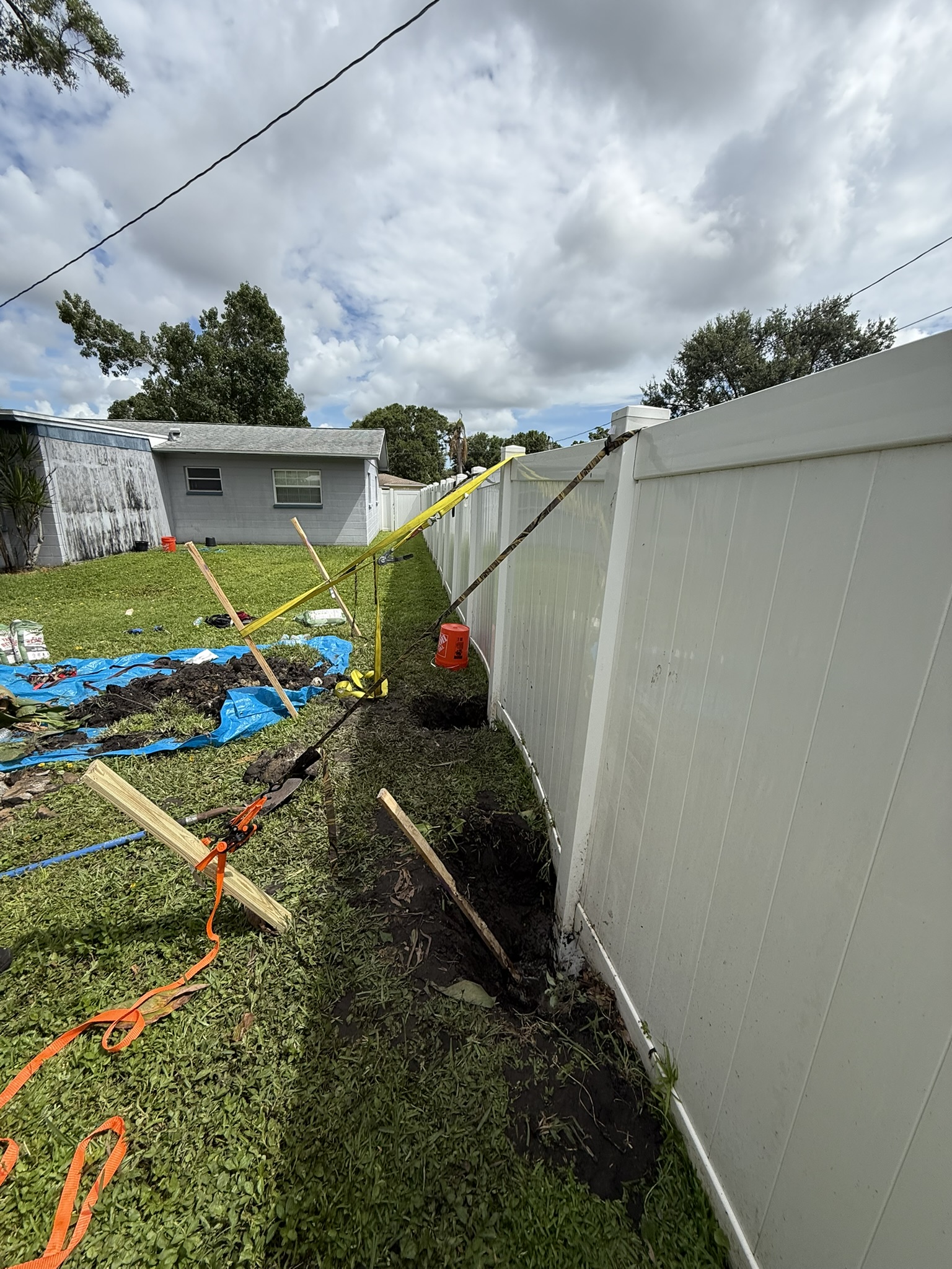 Vinyl fence repair with posts braced and reset